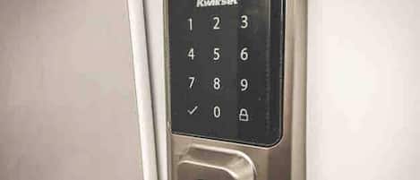 A Kwikset electronic keypad lock on a door.