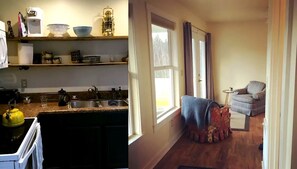 A compact kitchen with a sink, kettle, and various kitchen items on shelves. There is a window with curtains and a view of the outdoors. - Cozy Cabin in the Idyllic Blue Ridge Mountains, Virginia (Troutdale)
