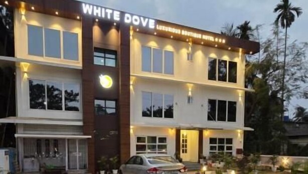 A multi-story building with a sign reading 'WHITE DOVE.' - White Dove Luxurious Boutique Hotel (Mikir Para Chakardoi)