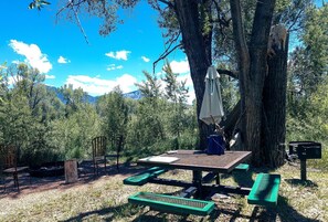 A picnic table with a bench, a picnic table with a bench, a picnic table with a bench, a picnic table with a bench, and a picnic table with a bench.