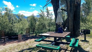 A picnic table with a bench, a picnic table with a bench, a picnic table with a bench, a picnic table with a bench, and a picnic table with a bench.