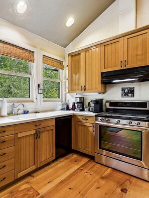 Coffee/tea maker, fridge, cookware/dishes/utensils, dining tables