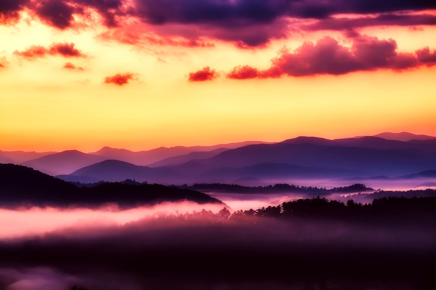 A mountainous landscape with layered hills and a valley.