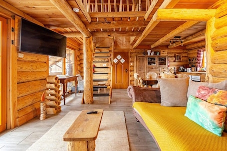TV, fireplace. Cabin 'Naturstammhaus Almhütte' with Mountain View, Private Terrace and Wi-Fi
