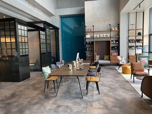 A modern conference room with a long table, chairs, and a 'PARTY' sign on the wall. - Moxy Shanghai Hongqiao Necc (Shanghai)