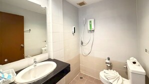 A bathroom with a sink, mirror, toilet, and shower. - Blue Neptuna Hotel Patong (Patong)