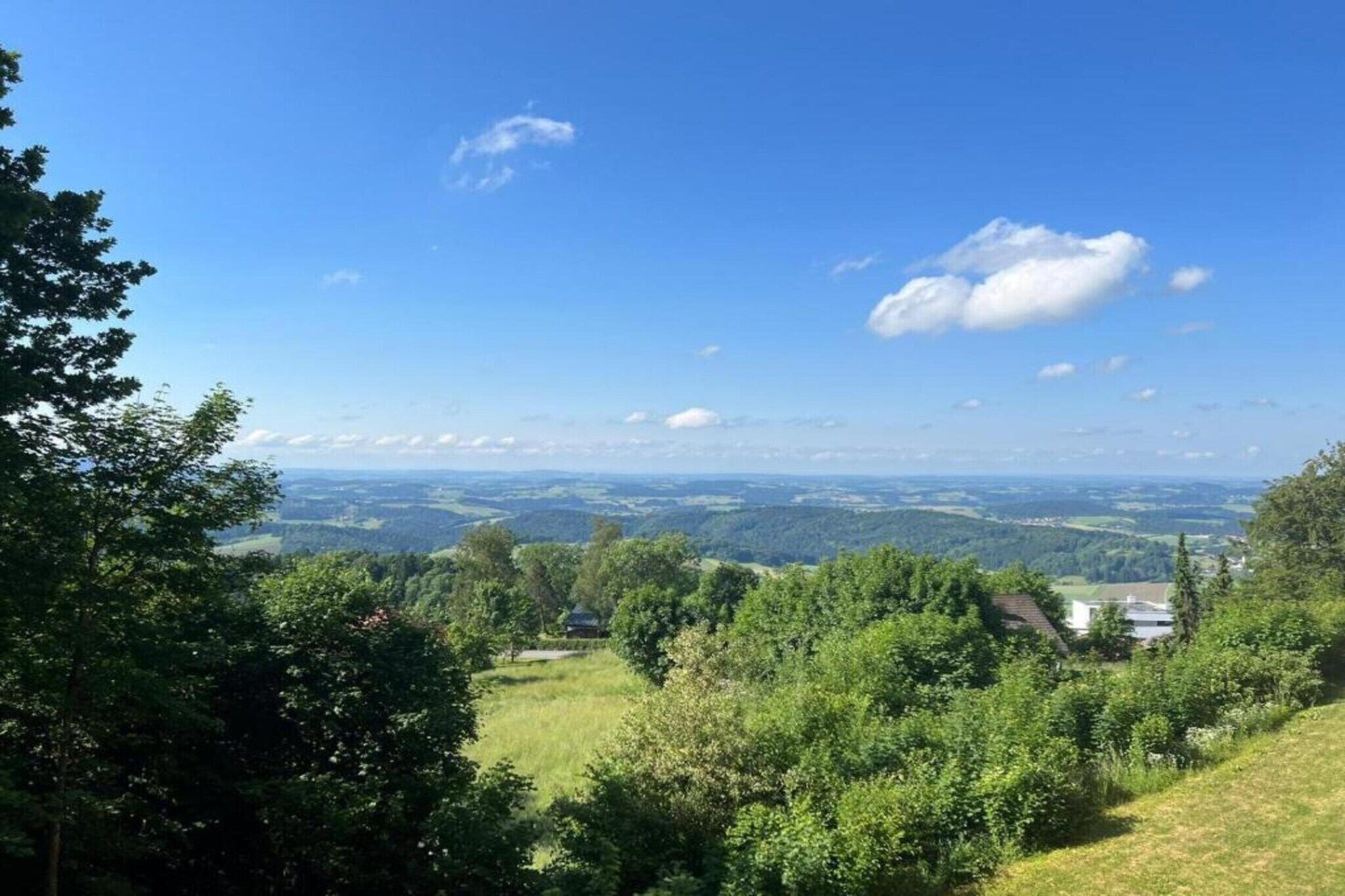 A panoramic view of a lush green landscape with a clear sky.