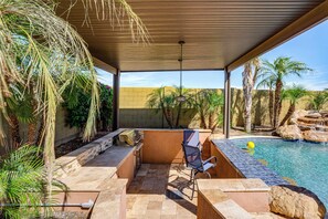 An outdoor patio with a grill, seating, and a pool. - Swim-Up Bar & Games! Ultimate Goodyear Group Stay (Goodyear)