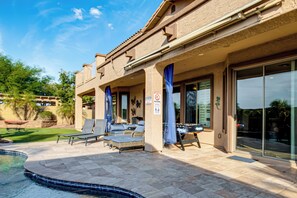 A pool area with lounge chairs, a hot tub, and a covered patio with a view of the pool. - Swim-Up Bar & Games! Ultimate Goodyear Group Stay (Goodyear)