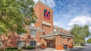 A brick building with a sign indicating 6 suites. - 1 King Bed | Non-Smoking, Kitchen (Milwaukee WI)