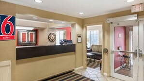 A hotel lobby with a reception desk, a clock, and an exit sign. - 1 King Bed | Non-Smoking, Kitchen (Milwaukee WI)