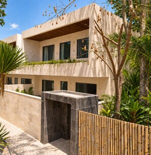 A modern two-story building with a flat roof, large windows, and a covered outdoor area. - Surfside Appartments & Villas (Pecatu)
