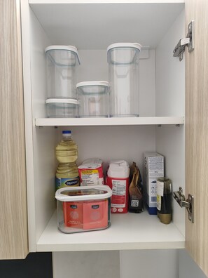 A pantry with clear storage containers, a large water jug, and various food items. - The Best offer! 2-bedroom apartment in Vracar with AC for relaxing stays (Beograd)