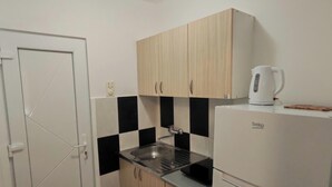 A compact kitchen with a sink, cabinets, a kettle, and a refrigerator. - The Best offer! 2-bedroom apartment in Vracar with AC for relaxing stays (Beograd)
