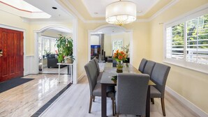 A dining area with a table, chairs, and a chandelier. - Room-cozy & Huge Primary Suite Near UBC (Vancouver)