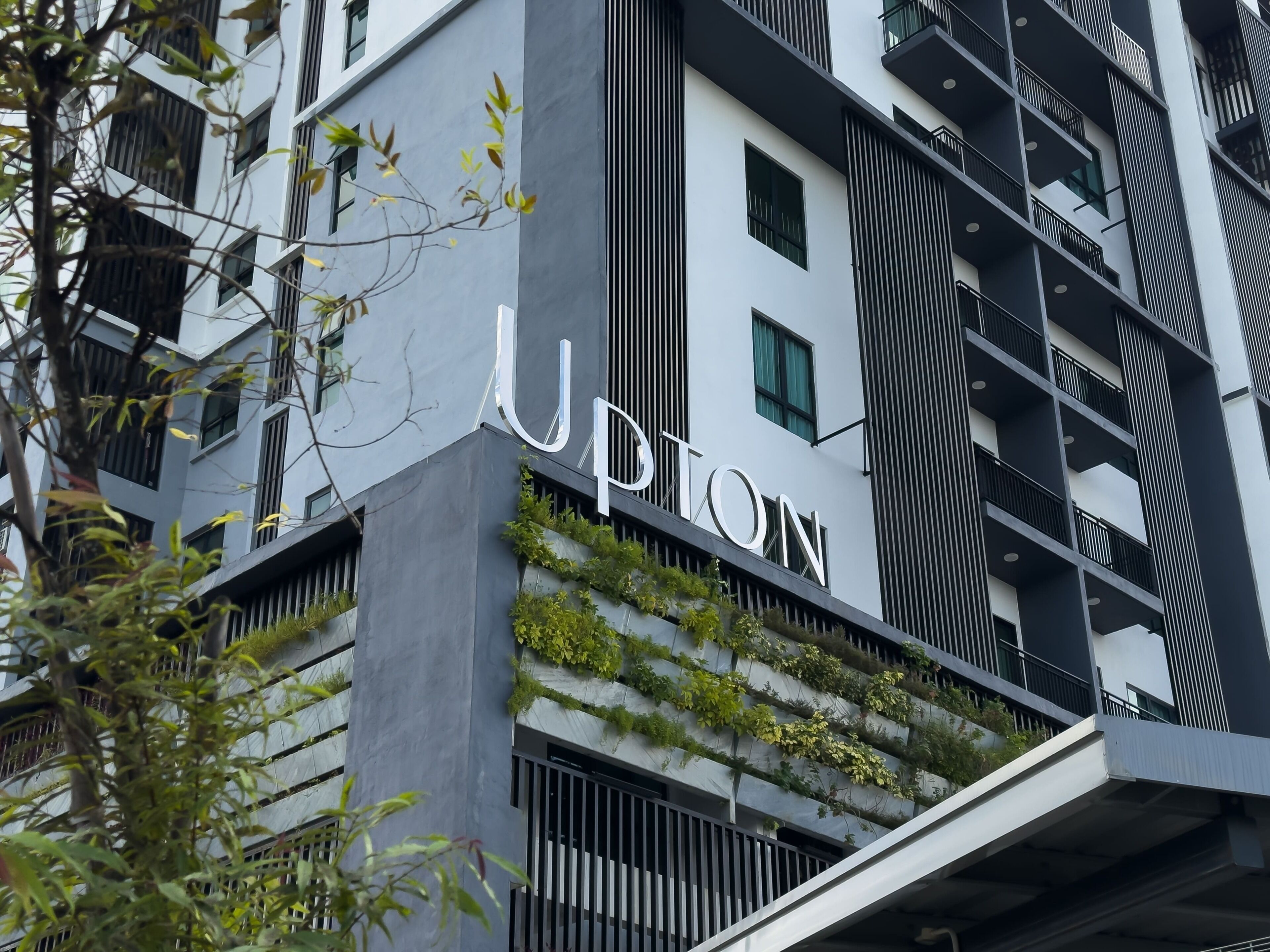 A modern building with the name 'UPTON' prominently displayed.