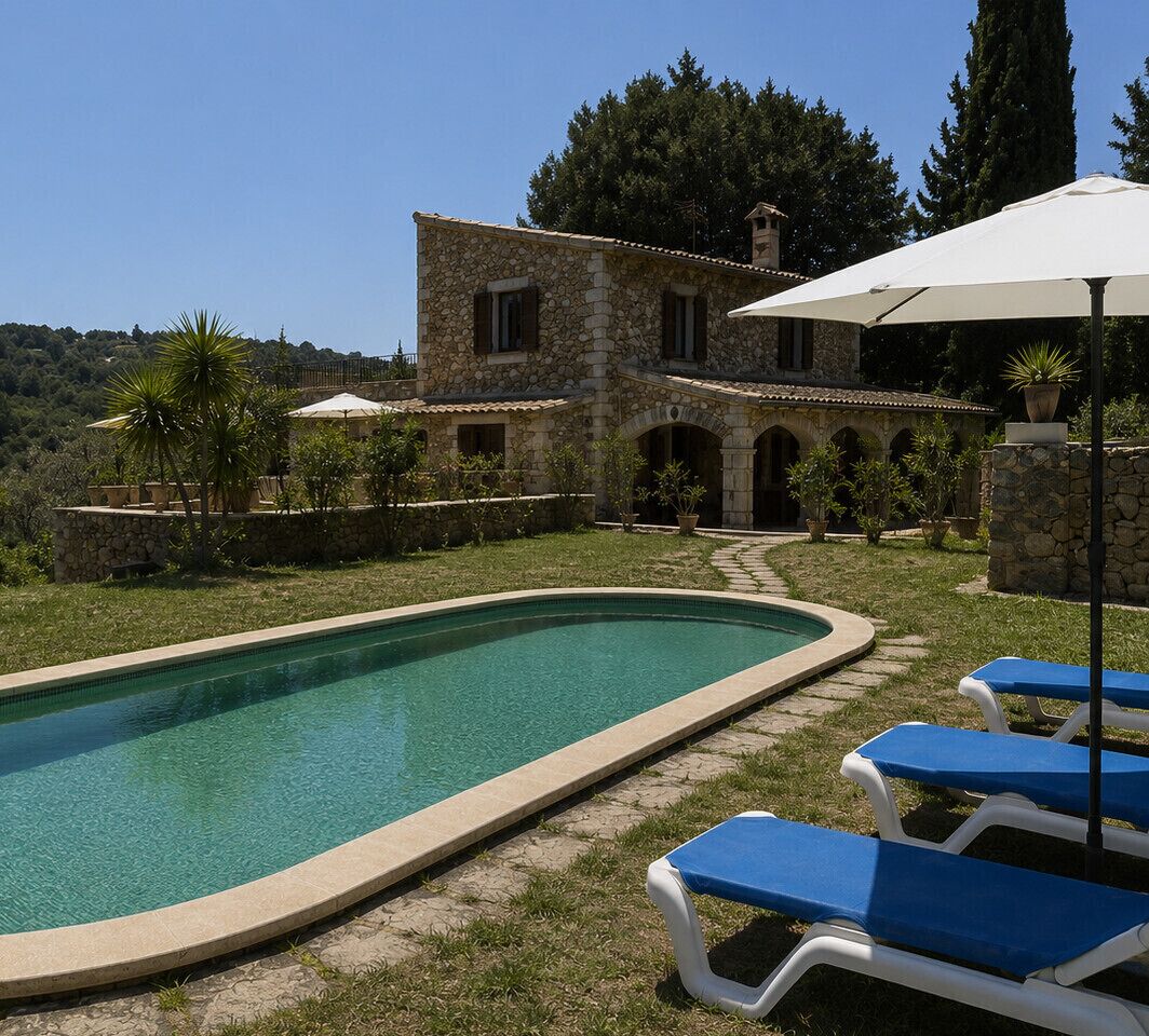 A stone villa with a swimming pool, outdoor seating, and a garden.