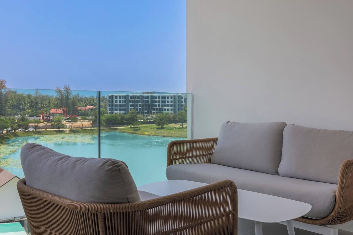 A balcony with a view of a body of water and a distant building.