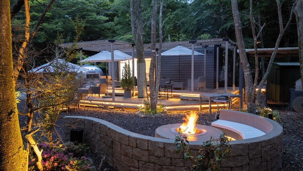 A patio area with a fire pit, outdoor seating, and a covered structure. - THE GUEST VILLAGE Hakone Ashinoko (Hakone)