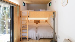 A compact room with a bunk bed, a ladder, a desk, and a window with a view of trees. - THE GUEST VILLAGE Hakone Ashinoko (Hakone)