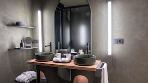 A modern bathroom with two large sinks, a mirror, and a towel rack. - Hotel Sarela Natura (Santiago de Compostela)