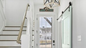 A staircase leading to a door with a sign that reads 'ON LAKE TIME.' - Lake Happy - Waterfront Paradise (Dadeville)