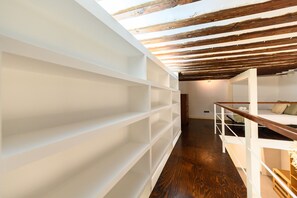 A loft bedroom with a wooden ceiling, white shelving, and a bunk bed. - (ESA121ID) Spacious Duplex in the center of Madrid (Madrid)