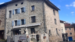 A stone building with a sign for 'SPARKING Boulangerie' and a bicycle parked outside.