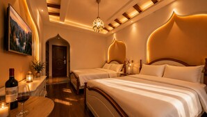 A hotel room with two beds, a chandelier, a painting, and a bottle of wine on a table. - Han Exotic inn (Zhangjiajie)