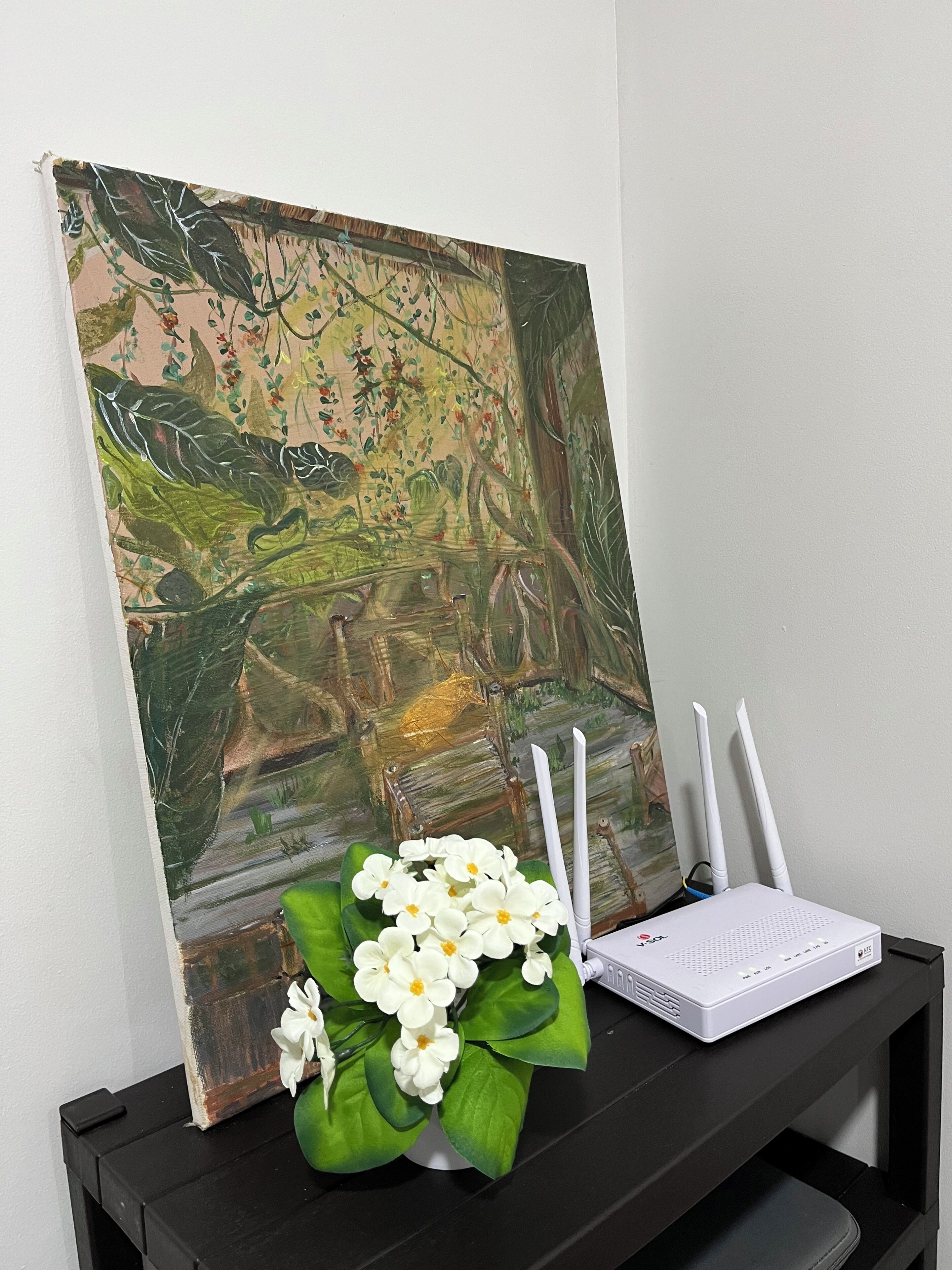 A painting of a tropical scene with a white flower arrangement on a black table.