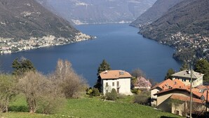 Un lac entouré de montagnes, avec des bâtiments situés sur la rive.