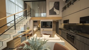 A modern interior with a staircase, a dining area, a living room, and a kitchen. - Urban 2br Apt in Central Area (Panama City)