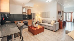 A modern living space with a dining area, kitchen, and a sofa. - Studio 3 Guests Balcony With Views Fishing Lodge (Punta Cana)