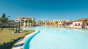 A resort with a large swimming pool, palm trees, and multi-story buildings. - Studio 3 Guests Balcony With Views Fishing Lodge (Punta Cana)