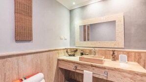 A bathroom with a wooden vanity, a mirror, a sink, and a towel rack. - Studio 3 Guests Balcony With Views Fishing Lodge (Punta Cana)