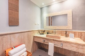 A bathroom with a wooden vanity, a mirror, a sink, and a towel rack. - Studio 3 Guests Balcony With Views Fishing Lodge (Punta Cana)