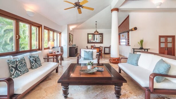 A spacious living area with a large window, a ceiling fan, and a central coffee table. - 3br Villa Private Pool 6 Guests in Casa de cam (La Romana)