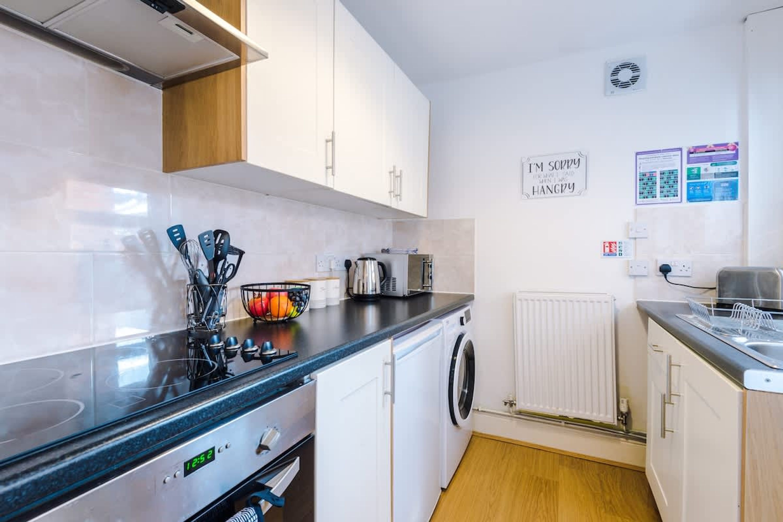 A modern kitchen with a microwave, toaster, and sink.