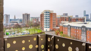 A cityscape with modern buildings, a green park, and a clear sky. - NEW Pristine 2-bed Flat Great Location Sleeps 6 (Liverpool)