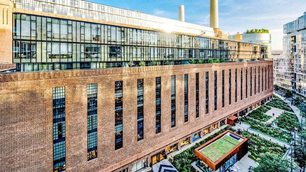 A modern building with large windows, a brick facade, and a rooftop garden. - NEW Pristine Apartment City Centre Amazing Views (London)