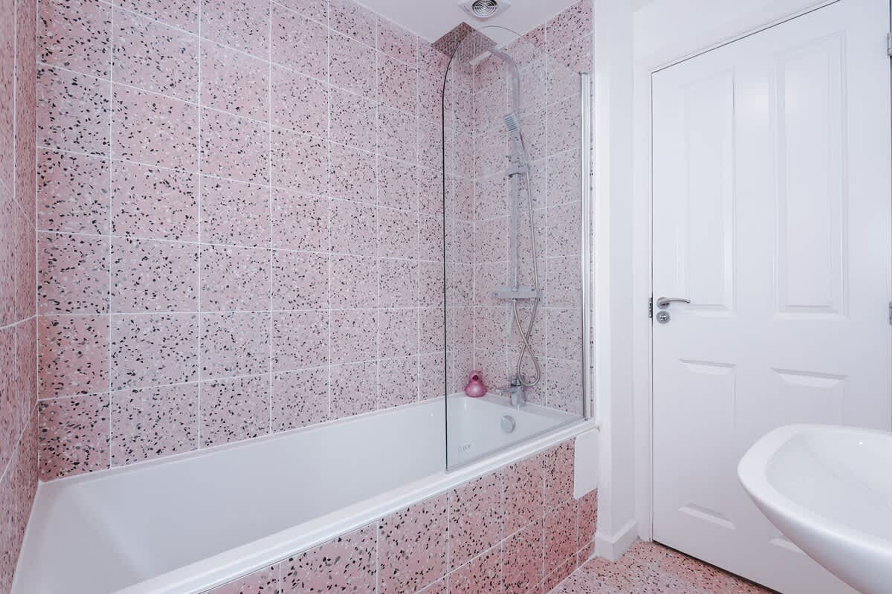A bathroom with a shower, a bathtub, and a sink.