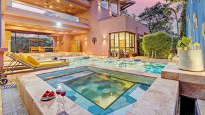A modern house with a swimming pool, outdoor seating, and a well-lit interior. - ELIVAAS Villa 39 Serene 6BHK with Pool (Lonavala)