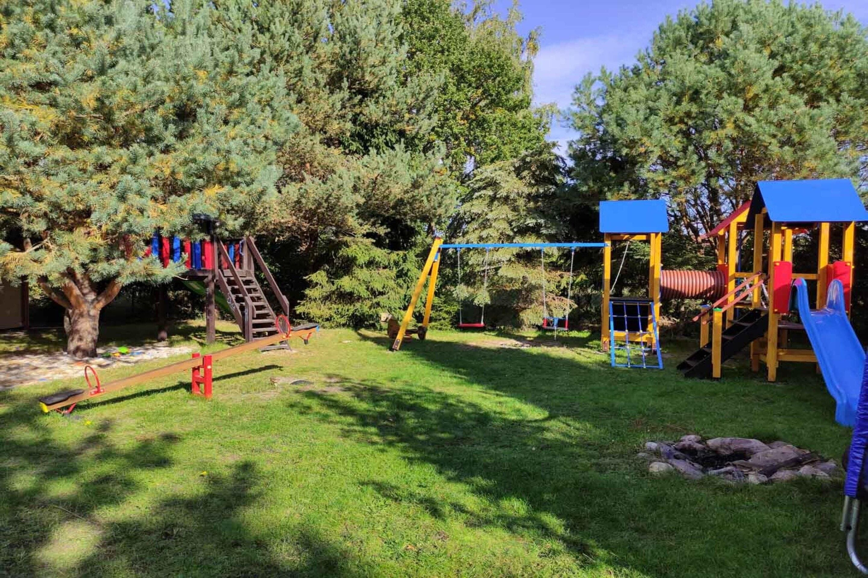 A playground with a slide, swings, and a climbing structure.