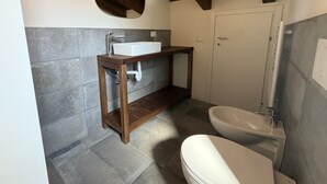 A bathroom with a toilet, a sink, and a bidet. - Enchantment of the Lake app Palanzo Studio Apartment with Terrace A/C (Molina)