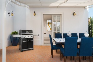 A patio with a grill, blue chairs, and a table. - Tremendous 4-bedroom villa Celeste by Casa del Sole with pool in Vabriga (Vabriga)