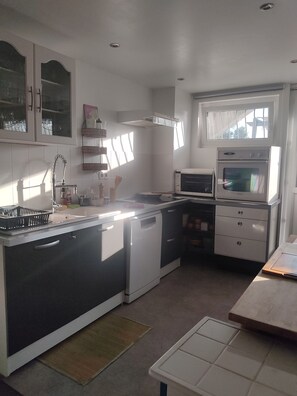 A compact kitchen with a dishwasher, a microwave, and a built-in oven.