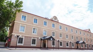 A multi-story hotel with a symmetrical facade, large windows, and a central entrance. - Pushkin Hotel (Uralsk)