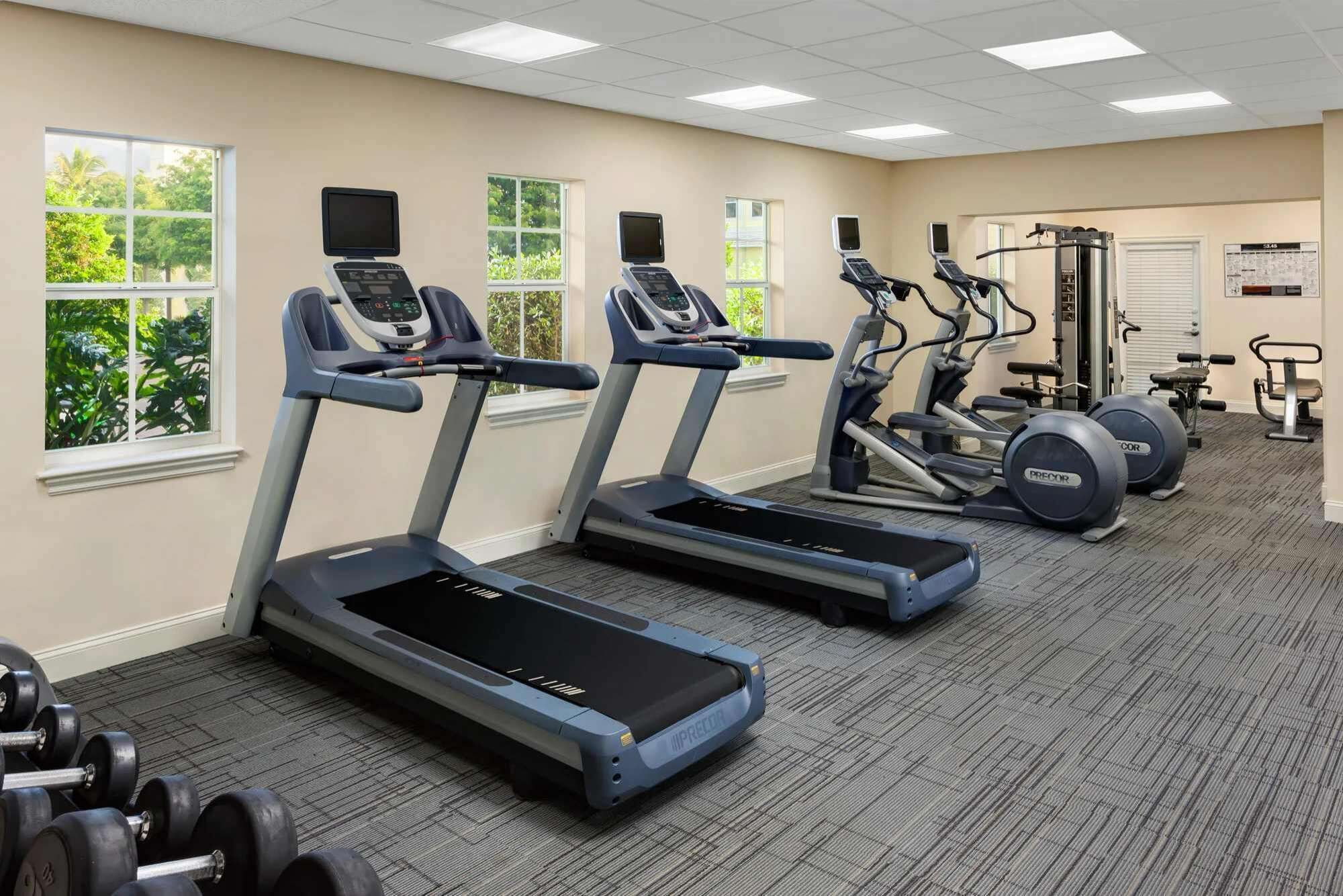A gym with treadmills, ellipticals, and weight machines.