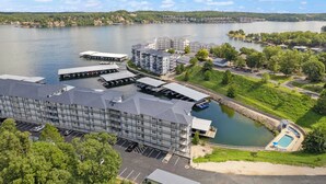 A hotel with multiple buildings, a dock, and a swimming pool.