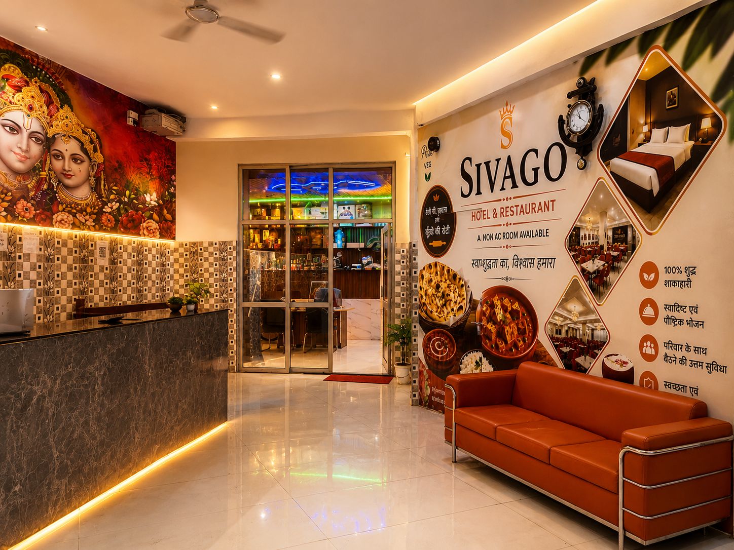 A hotel lobby with a reception desk, a seating area, and a wall with promotional material.